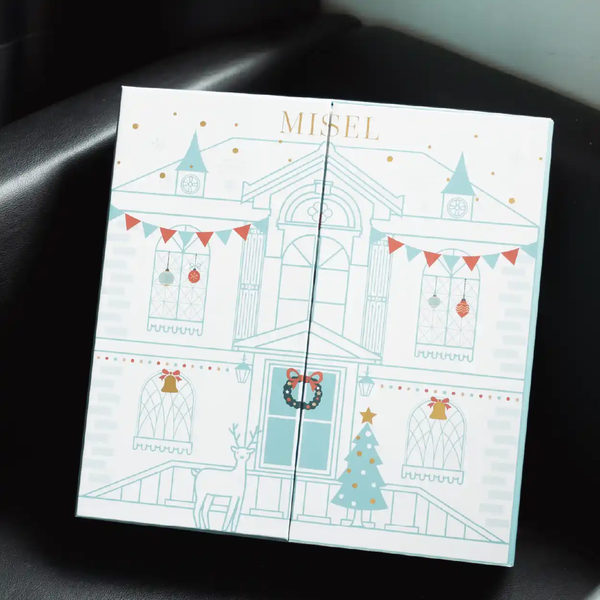 Christmas countdown calendar case with "MISEL" printed on it.