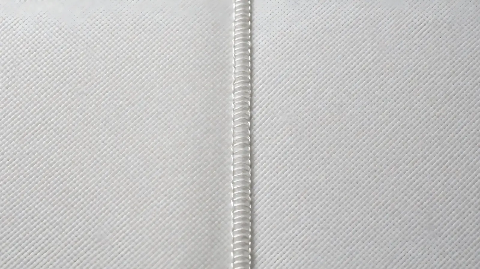 Comparative manufacturing view of patterned ultrasonic weld seams versus heavy-duty thread stitching on polypropylene non-woven reusable bags