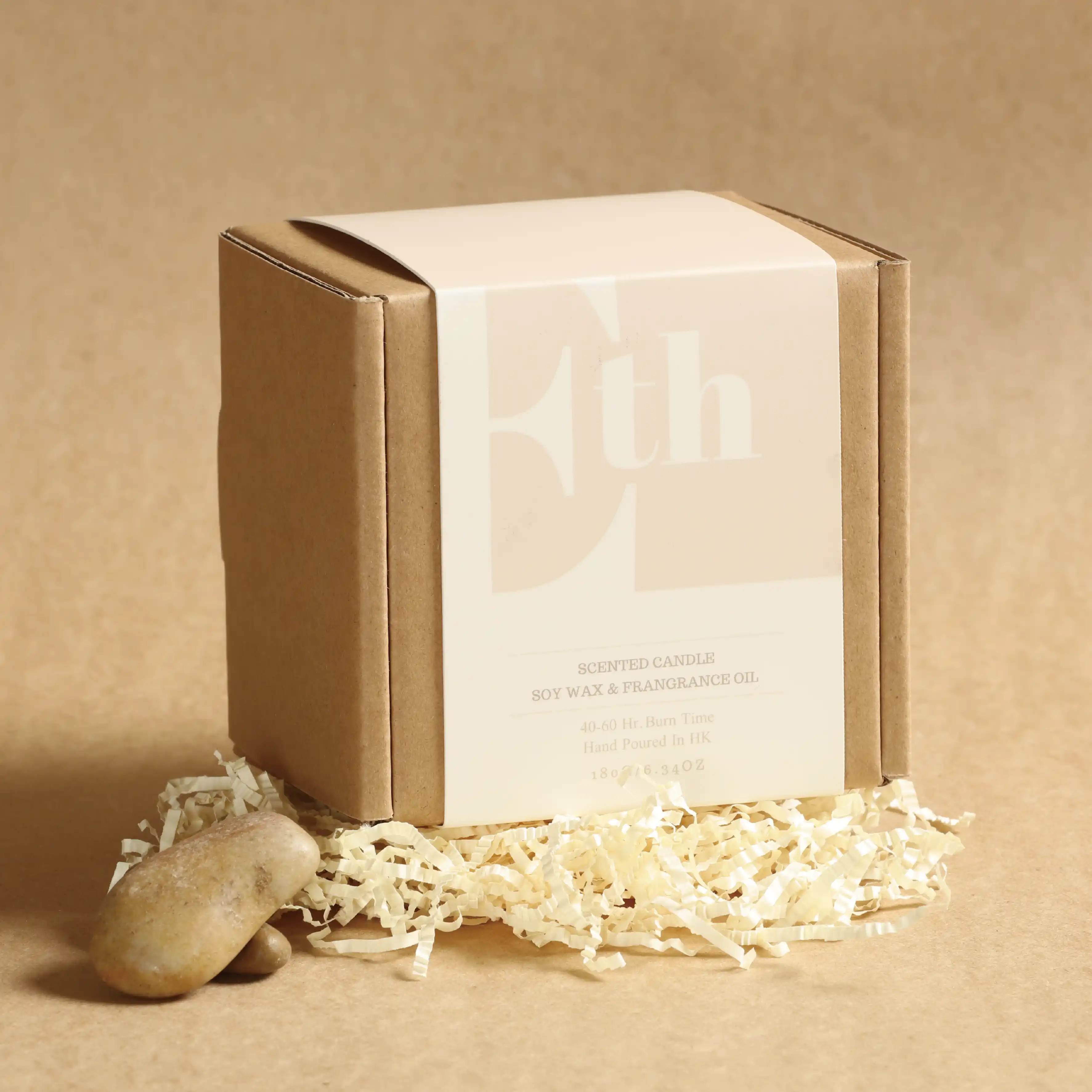 A colourful perimeter striped mailing box on a khaki background with white padded paper strips added to the bottom