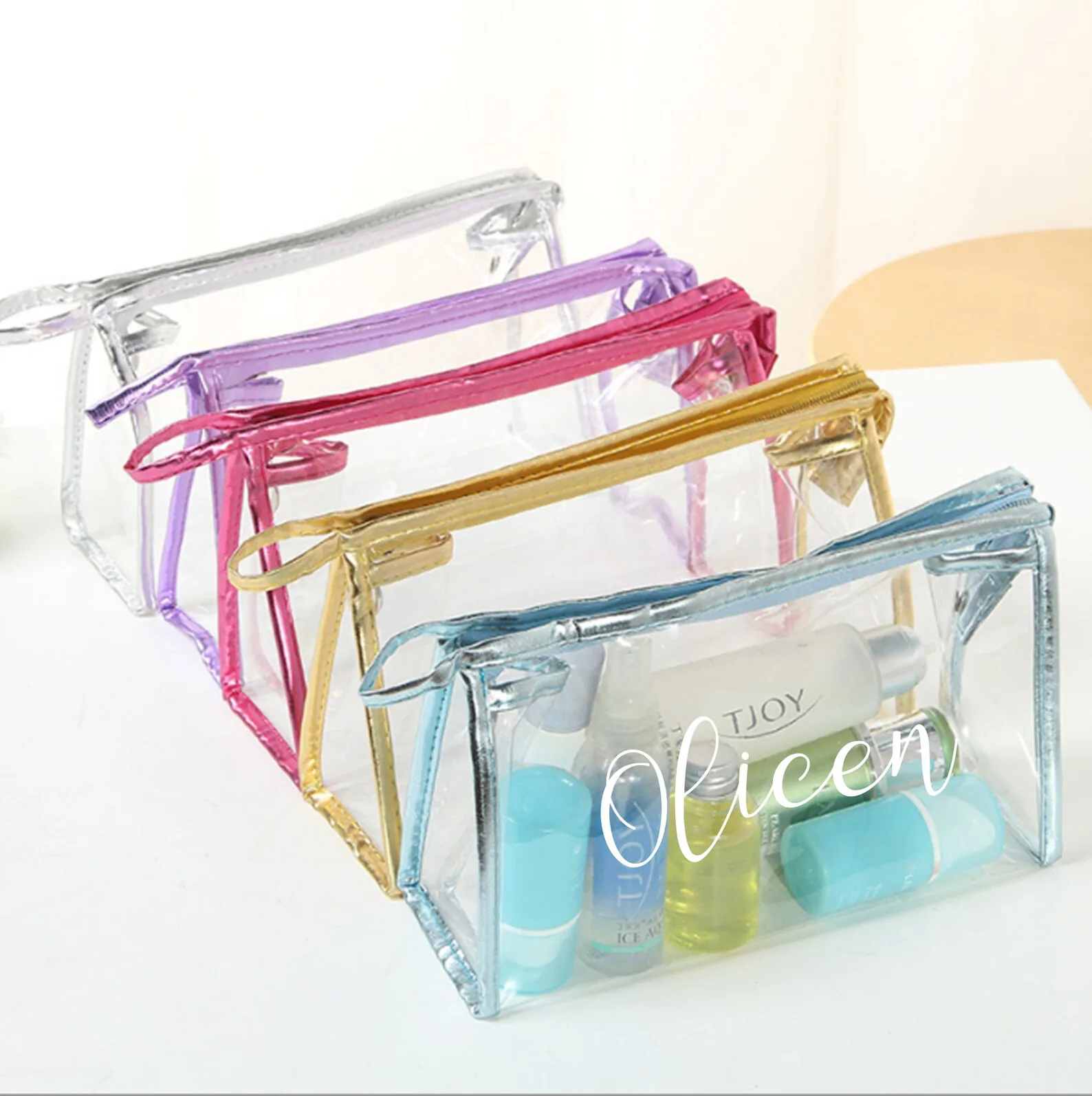 Clear PVC zipper cosmetic bags with silver, purple, pink, gold, and blue trim